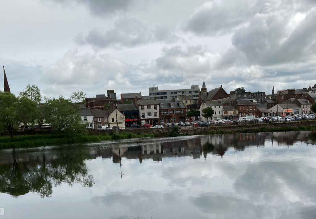The Sands parking area, with Greyfriars Church steeple on the far left, from across the River Nith, Dumfries
