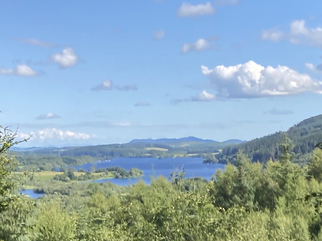 The view over Loch Ken, immortalised by the artist James Faed the Younger in his painting 'The Town Park', offers a timeless perspective into this vibrant landscape.