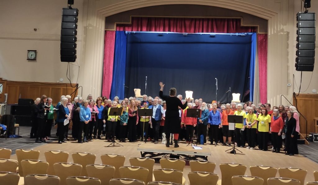 The sound check for the combined choirs, doubling up as a rehearsal
